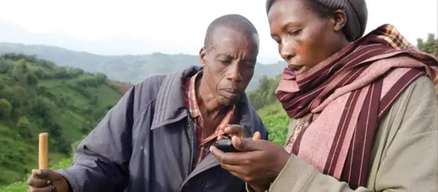 Farmers in Malawi using a mobile phone to access information