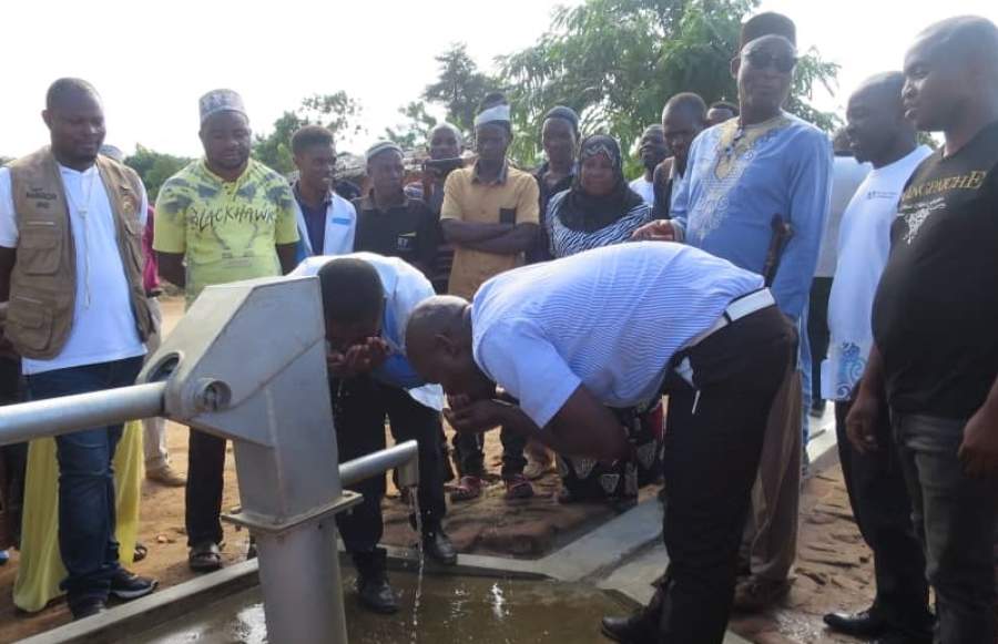 People appreciating water quality from one of the boreholes